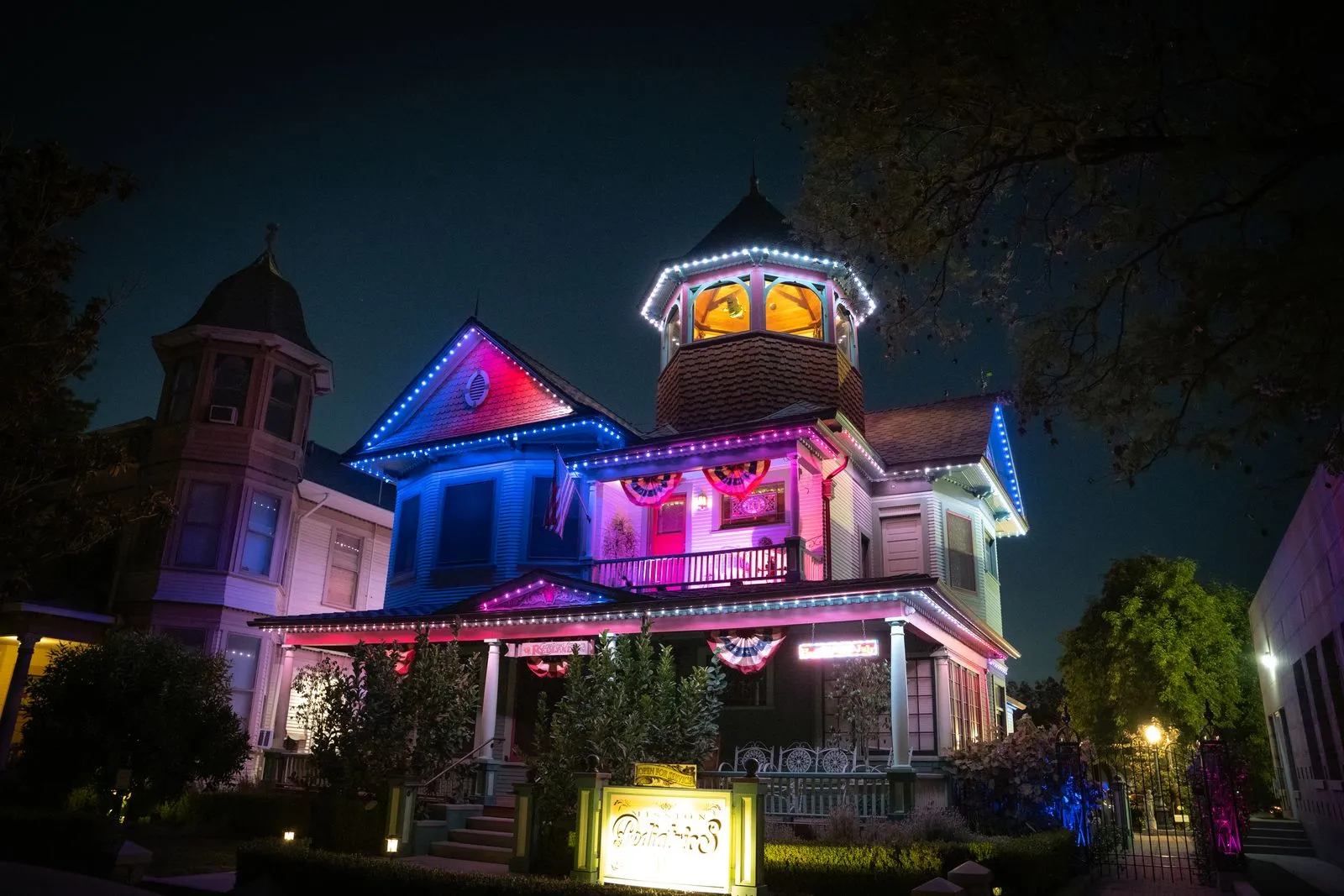 A home lit in multiple colours across the roofline