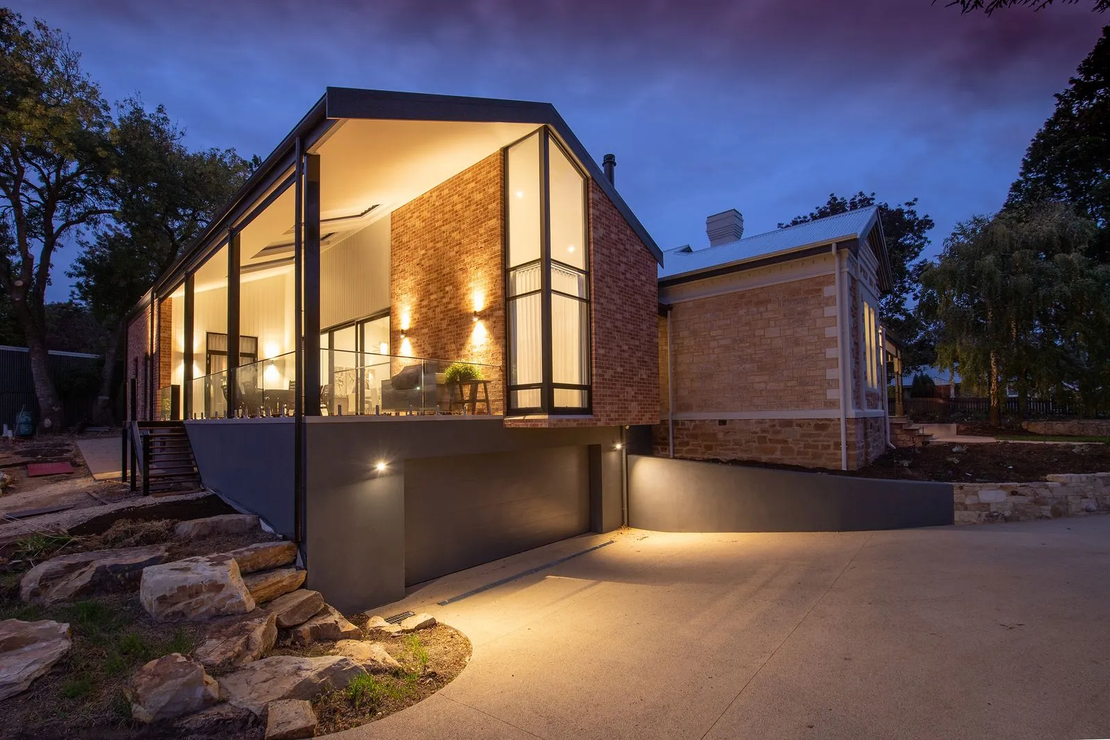 A modern home with permanent accent lighting after dark